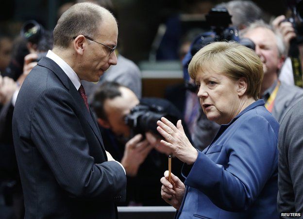 Italy PM Enrico Letta listens to German Chancellor Angela Merkel, 19 Dec 13