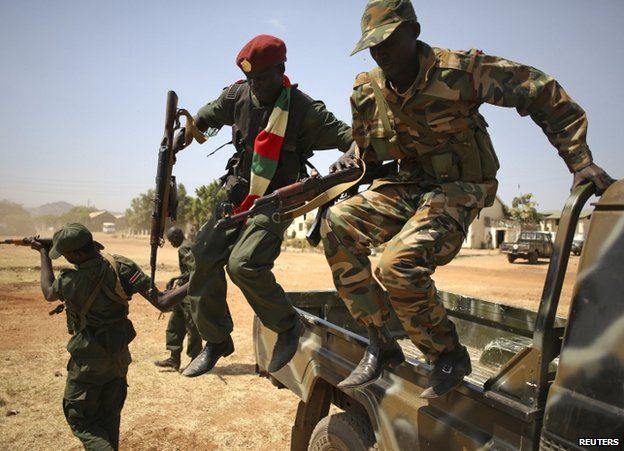 SPLA soldiers leap from a pick-up truck in Juba, 21 December