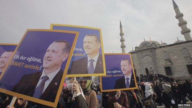 Supporters of the ruling AK Party hold posters of Turkey"s Prime Minister Tayyip Erdogan during a demonstration in support him in Istanbul December 27, 2013