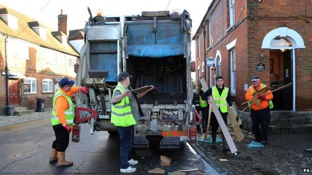 Workmen clear debris from homes in Yalding, Kent, after it was flooded during the recent bad weather.