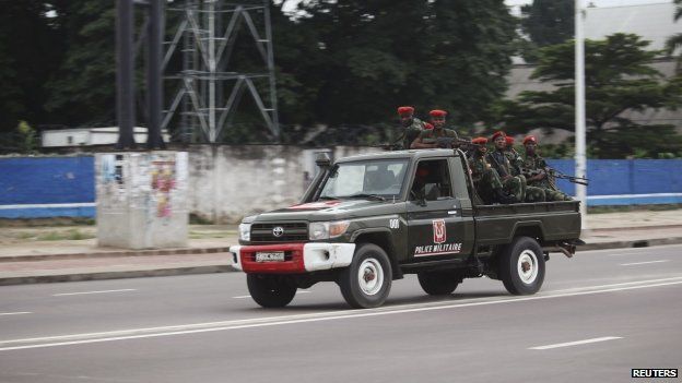 Congolese soldiers ride on their pick-up truck towards the state television headquarters in the capital Kinshasa, 30 December 2013