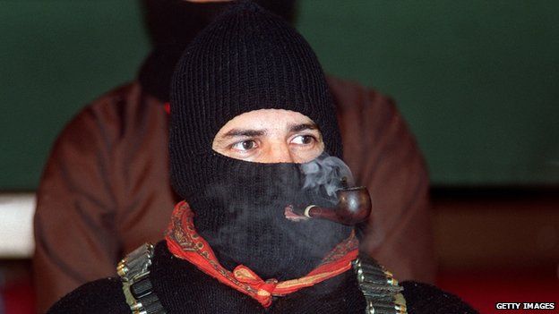 Zapatista National Liberation Army leader Subcomandante Marcos smokes a pipe during peace talks on 24 February, 1994, in San Cristobal, Mexico