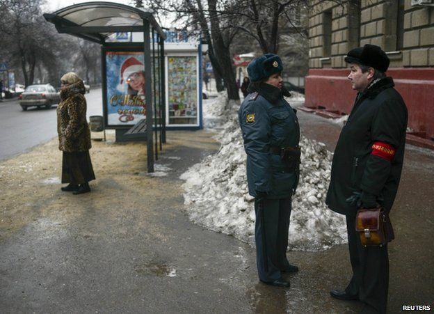 A policewoman speaks to a neighbourhood watch volunteer in Volgograd, 31 December
