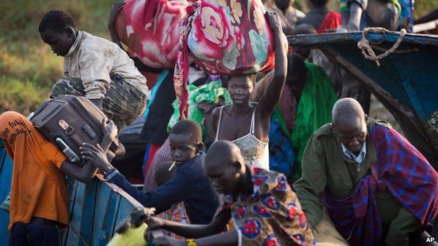 Displaced people disembark from the river barges that brought them from Bor to Awerial in South Sudan on 2 January 2014