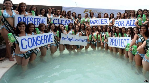 Contestants to the Ms. Philippines-Earth beauty pageant pose for photos inside a pool during the press presentation in Manila on 22 April 2013