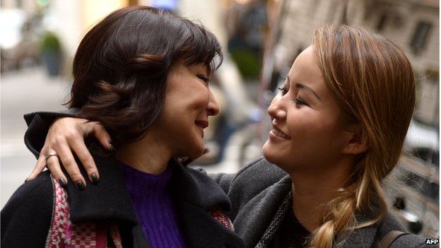 Alma Shalabayeva (L) is welcomed by her daughter Madina as she arrives for a press conference after she arrived in Rome on December 27, 2013