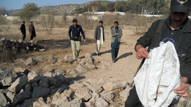 Pakistani security personnel examine the site of a suicide bombing in the Ibrahimzai area of Hangu district on January 6, 2014.