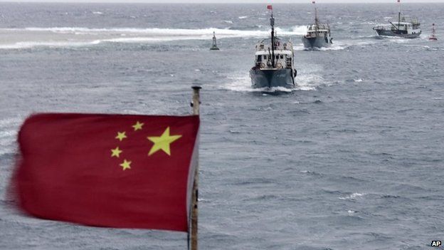 Chinese fishing boats sail off Hainan in the South China Sea on 20 July 2012