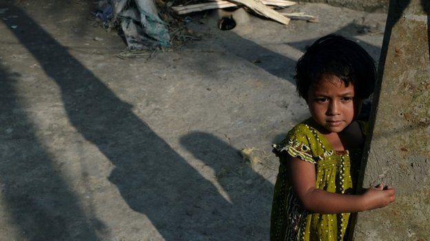 The last polio patient registered in India, three year-old Rukhshar Khatoon looks on outside her home in West Bengal