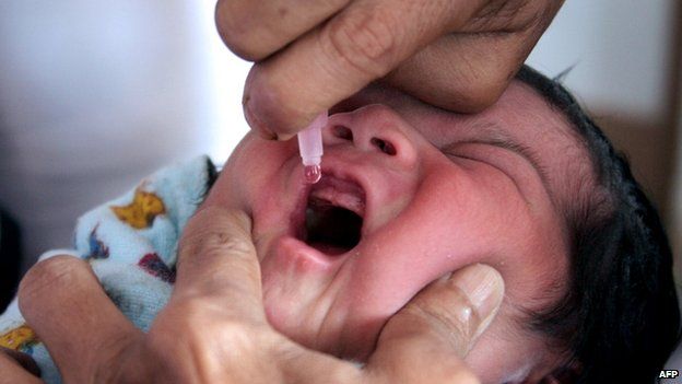 A child in India receives oral polio vaccine