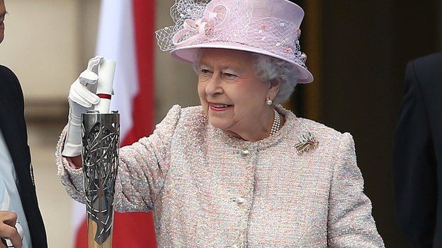Queen Elizabeth II places her message to the Commonwealth Games in the Commonwealth Games Baton, during its launch ceremony