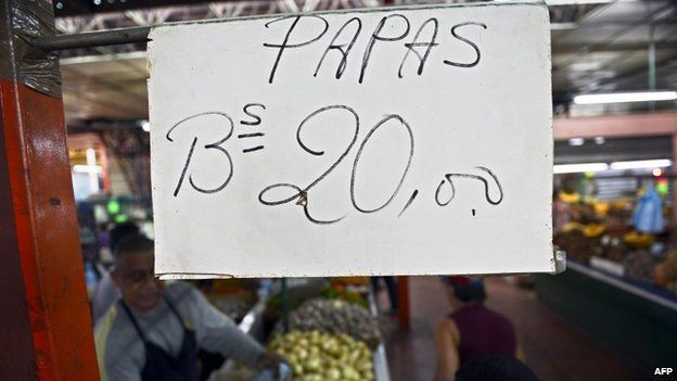 A sign displays the price of potatoes at a popular market in Caracas on 24 October, 2013