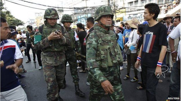 Thai military medics walk near the scene following an explosion at an anti-government protest camp at the Victory monument in central Bangkok January 19