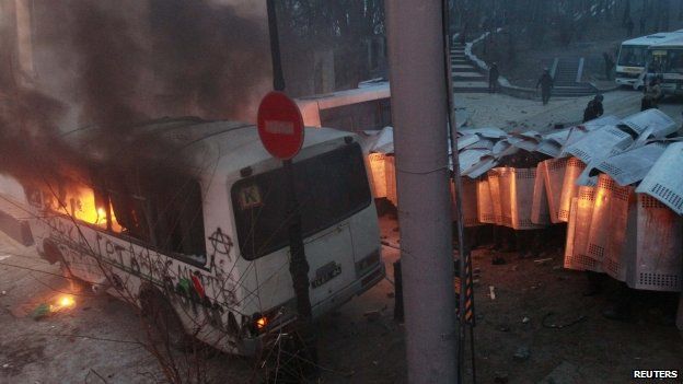 Police van which was attacked after a pro-European integration protest burns