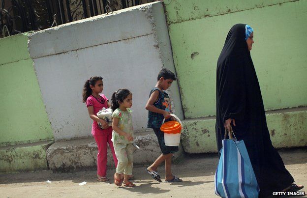 Family walking in Baghdad, Iraq in July 2011