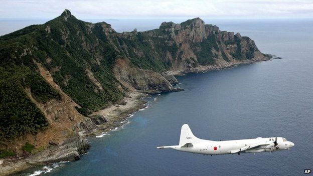 A 2011 file photo shows a Japanese surveillance plane flying over the disputed islands in the East China Sea