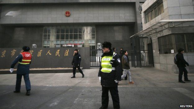 Policemen stand guard in front of a court where Chinese dissident Zhao Changqing's trial is being held in Beijing, 23 January 2014