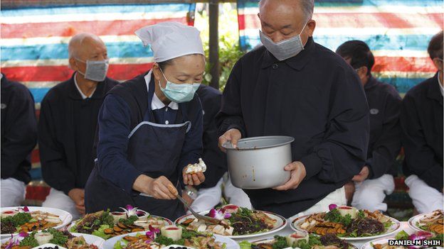 Volunteers serve food at a Tzu Chi event on 18 January 2014