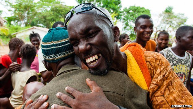 Alfredo Duquesne and Sierra Leone villager embrace in Mokpangumba