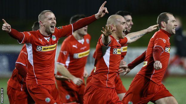 Cliftonville players celebrate the shoot-out victory
