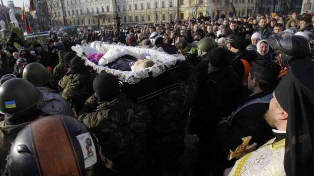 Crowds chanted "Hero!" as the open coffin of Mikhail Zhiznevsky, 25, was carried through the streets of the capital.