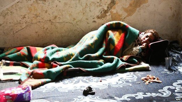 A sick Syrian refugee lies on the floor of an abandoned building in Istanbul, Turkey (27 January 2014)