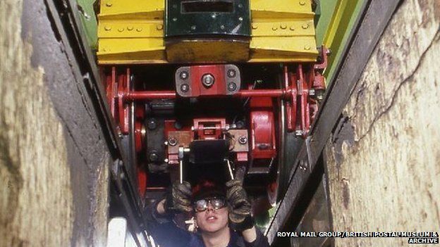 Engineer works on train in Car Depot