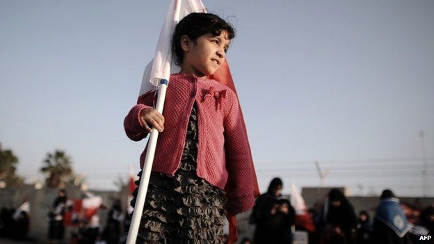 A young girl holds a Bahraini flag at an anti-government protest in Diraz, west of Manama (17 January 2014)
