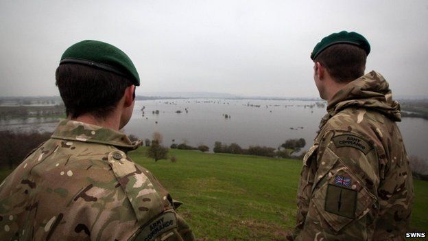 Two commandoes look out over flooded fields