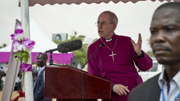 The Archbishop of Canterbury Justin Welby speaks to the local congregation outside a church in Juba, South Sudan Thursday, Jan. 30, 2014