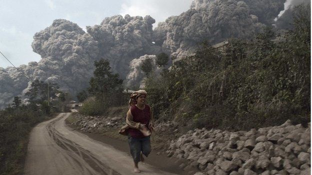 A villager run as Mount Sinabung erupt at Sigarang-Garang village in Karo district, Indonesia's North Sumatra province, February 1