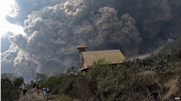 A giant cloud of hot volcanic ash clouds engulfs villages in Karo district during the eruption of Mount Sinabung volcano located in Sumatra on February 1