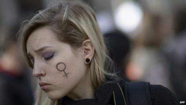 A woman with a Venus symbol on her cheek takes part in a protest against a reform of the Spain's abortion law in Madrid on 1 February 2014.
