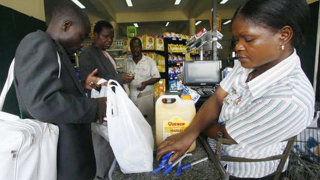 A cashier at Food World, a supermarket in Zimbabwe's capital