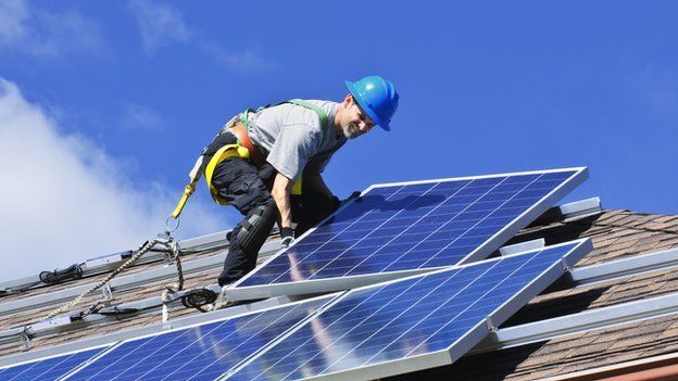 A man installing solar panels