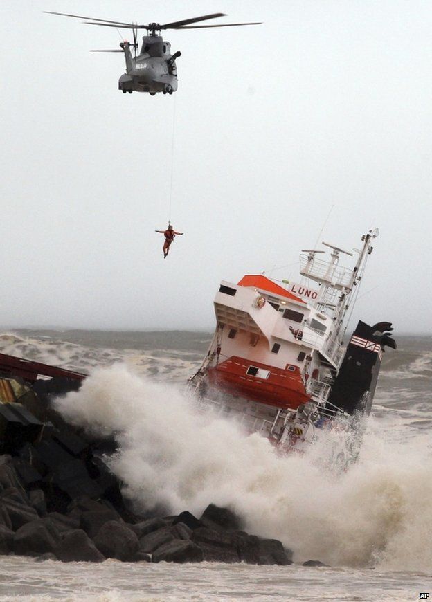 A helicopter with a man on a winch hovers near the stricken Luno, at Anglet on the French Atlantic coast, 5 February