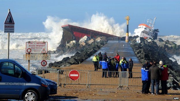 Emergency workers observe the stricken Luno, at Anglet on the French Atlantic coast, 5 February