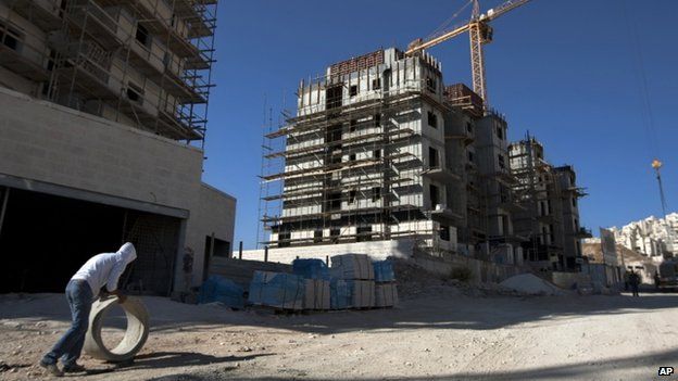 A construction worker works at a site of a new housing unit in the East Jerusalem neighbourhood of Har Homa in November 2011