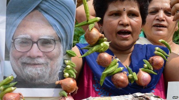 Women"s Welfare Organisation activists are pictured with an effigy of Indian Prime Minister Manmohan Singh, seen garlanded with vegetables including onions, during a demonstration in Amritsar on August 22, 2013.