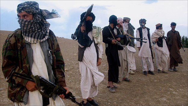 Taliban militia stand on a hillside at Maydan Shahr in Wardak province, Afghanistan, in September 2008