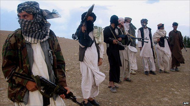 Taliban militia stand on a hillside at Maydan Shahr in Wardak province, Afghanistan, in September 2008