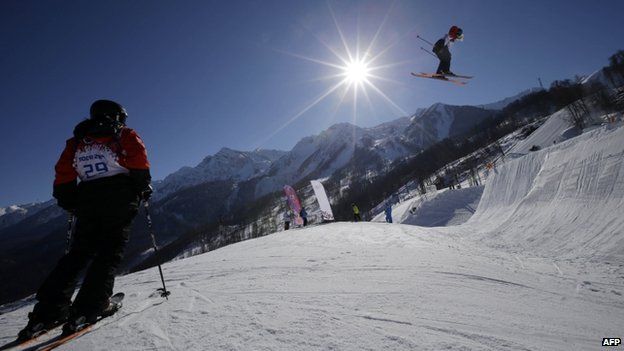 Paraguay's Julia Marino, left, watches other competitors during a ski slopestyle training session at the Rosa Khutor Extreme Park on 5 February, 2014