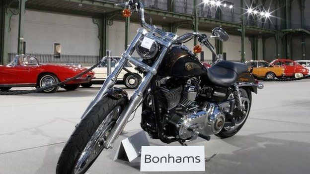 The 1,585 cc Harley Davidson Dyna Super Glide, donated to Pope Francis last year and signed by him on its tank, is displayed as part of Bonham"s Les Grandes Marques du Monde vintage and classic cars sale at the Grand Palais in Paris