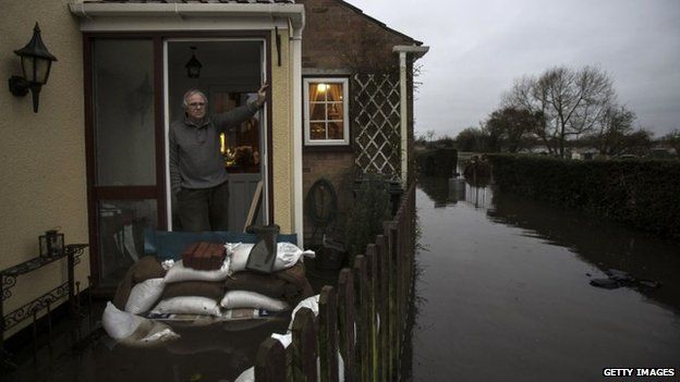 Phil Smithen at flooded house in Moorland