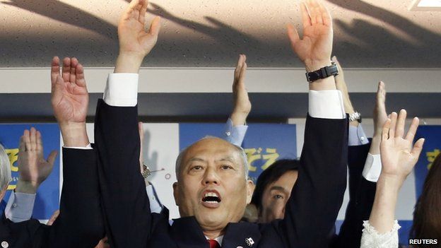 Japan's former health minister Yoichi Masuzoe cheers with supporters at his office in Tokyo 9 February 2014
