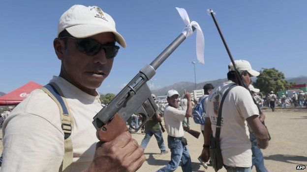 Armed residents take part in a march for the first anniversary of the citizen's vigilante groups, in Ayutla de los Libres, on January 5, 2014, in the south-eastern state of Guerrero, Mexico