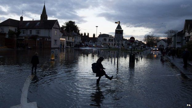 A child playing in flood water in Datchet, Berkshire