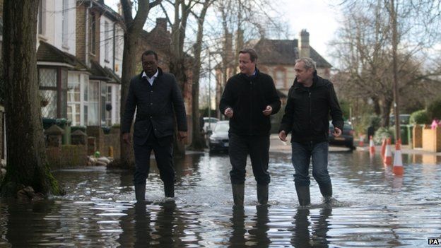 David Cameron with Spelthorne MP Kwasi Kwarteng (left) and a local resident