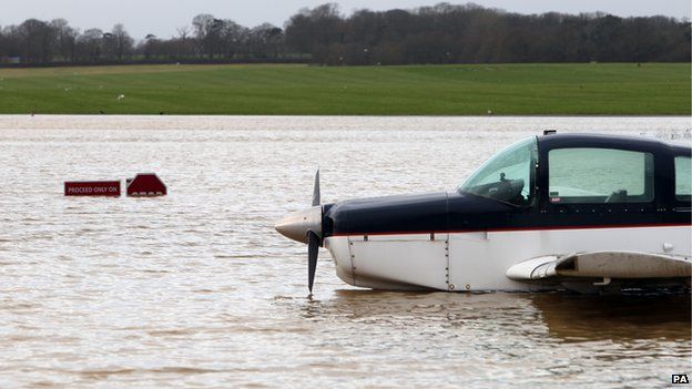 A plane sits in flood water at Redhill aerodrome after heavy rain