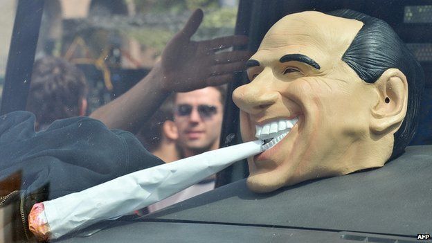A mask of Italy's Prime Minister Silvio Berlusconi smoking a joint is displayed in a van during the Million Marijuana March on 9 May 2009 in Rome.